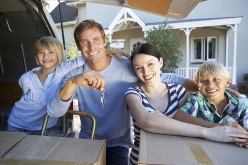 Movers handling furniture and boxes during a Mayfair business relocation